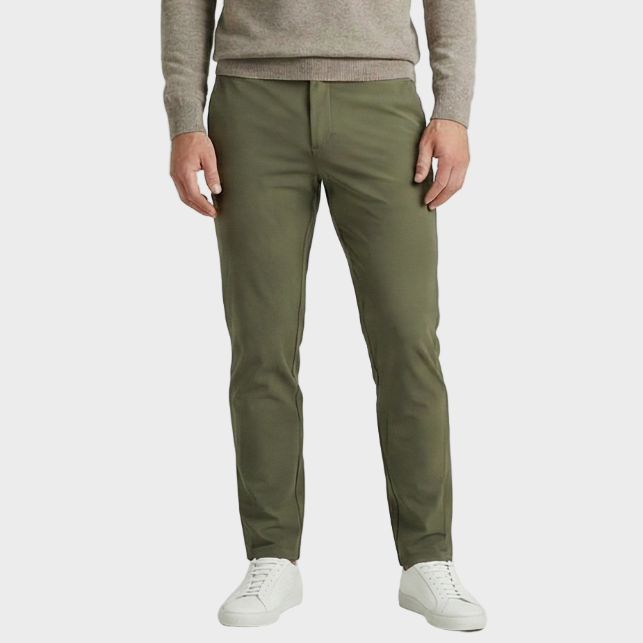 Person wearing olive green pants and a beige sweater on a white background