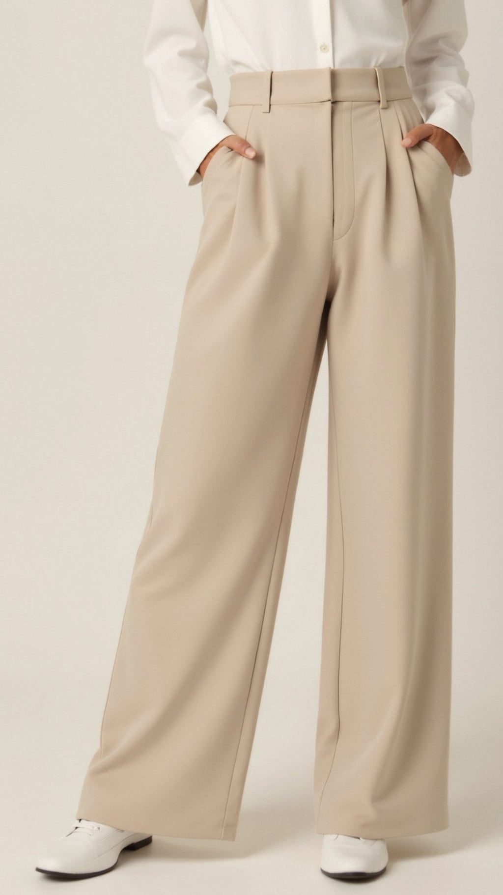Beige wide-leg pants worn with a white shirt on a beige background cream
