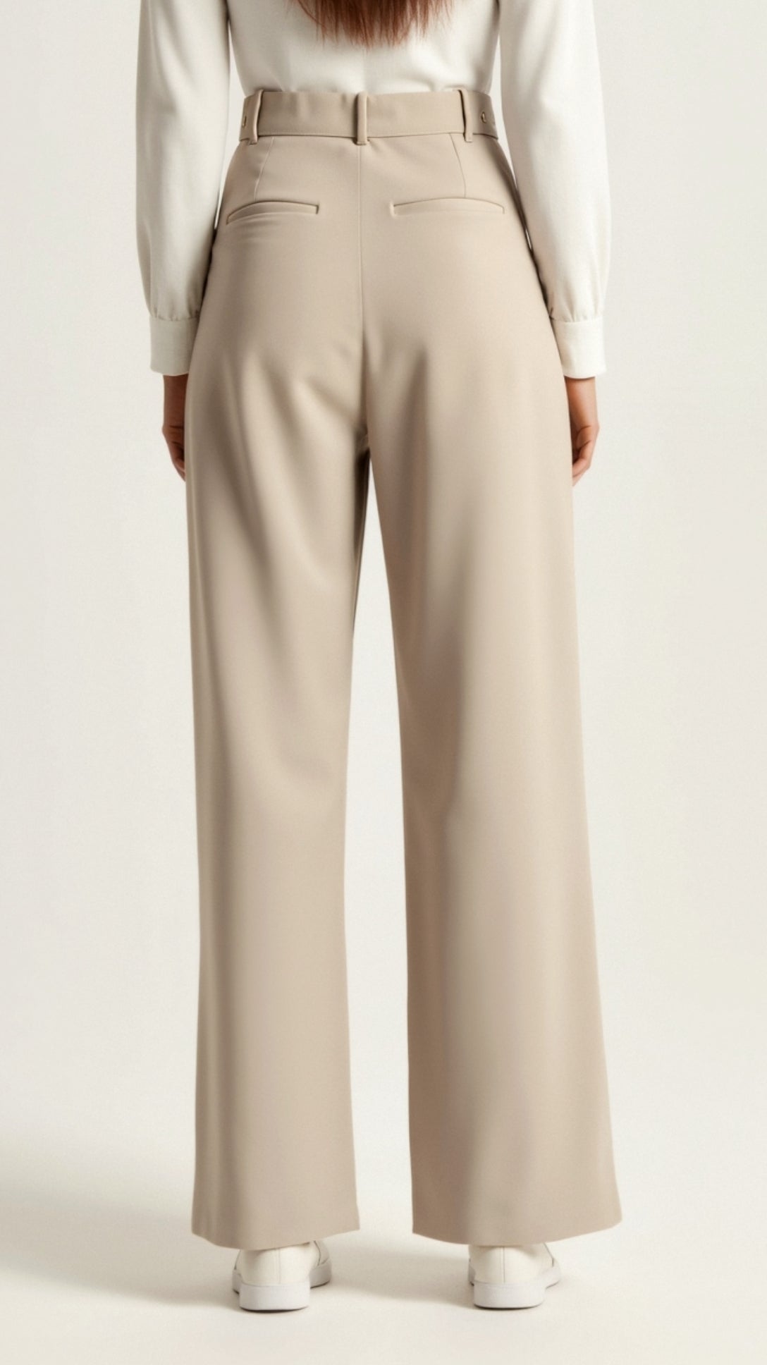 Beige wide-leg pants worn by a person on a white background cream